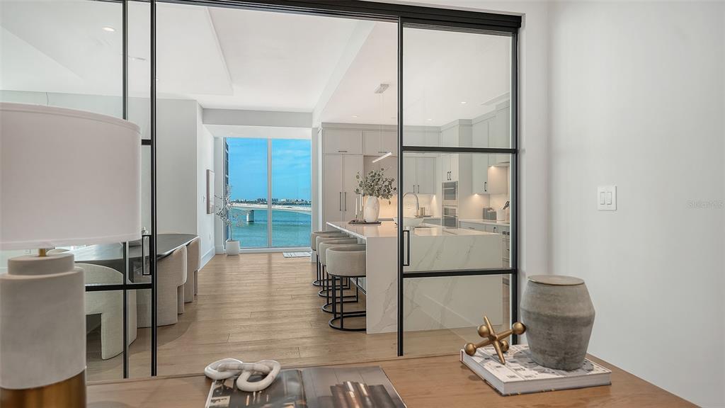 253 Golden Gate Point, Unit 703 Sarasota, FL 34236 - Photo 21 of 51 a room with table and chairs