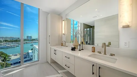 a spacious bathroom with double vanity and a mirror
