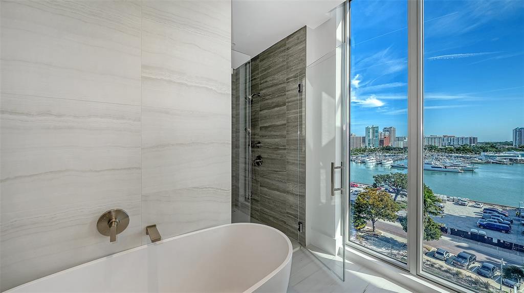 253 Golden Gate Point, Unit 703 Sarasota, FL 34236 - Photo 27 of 51 a bathroom with a bathtub and shower