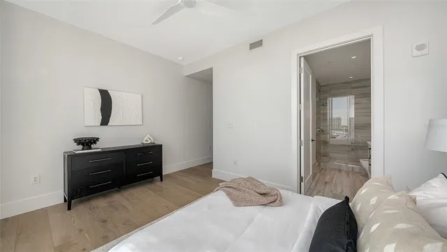 a bedroom with a bed and a mirror