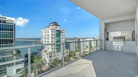 a balcony with table and chairs