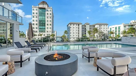 a living room with patio furniture and a large window