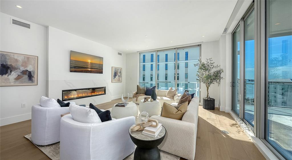 253 Golden Gate Point, Unit 703 Sarasota, FL 34236 - Photo 5 of 51 a living room with furniture and a large window