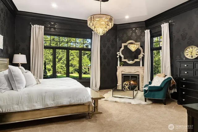 a bedroom with a bed fireplace and a large window