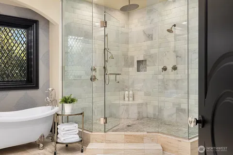 a bathroom with a bathtub and shower