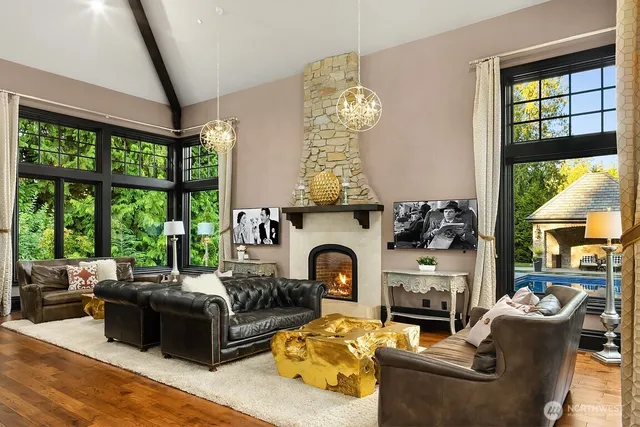 a living room with furniture fireplace and a large window