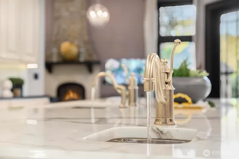 a view of living room with furniture and a fireplace