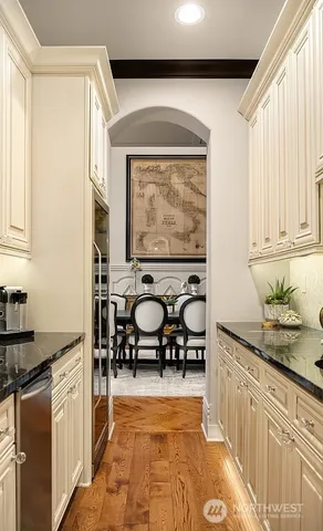 a kitchen with stainless steel appliances granite countertop a stove a sink and a microwave