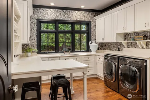 a kitchen with a stove a sink and a refrigerator with wooden floor