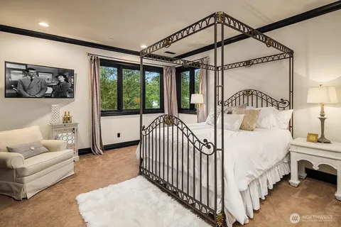 a bedroom with bed and a large window