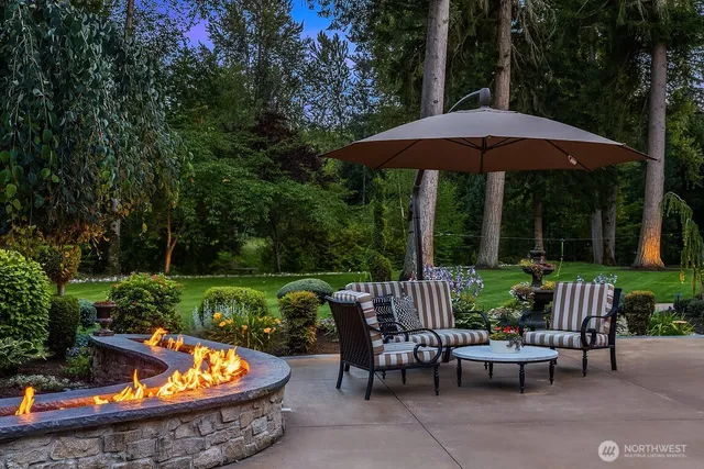 an outdoor sitting area with furniture and umbrella