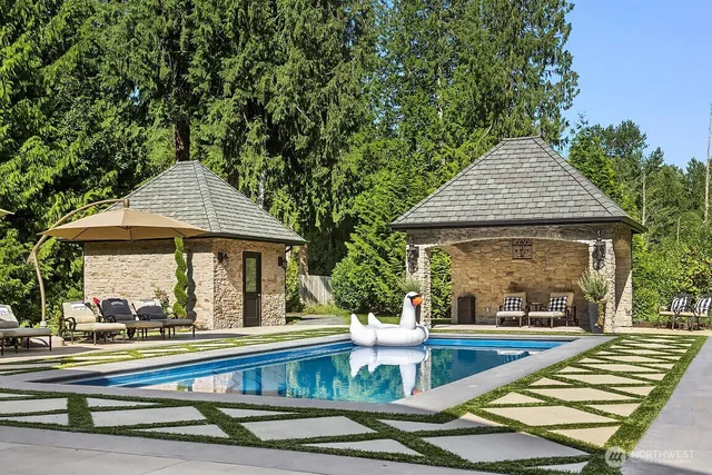 a view of house with swimming pool and porch with furniture