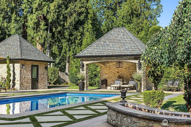 swimming pool view with a seating space