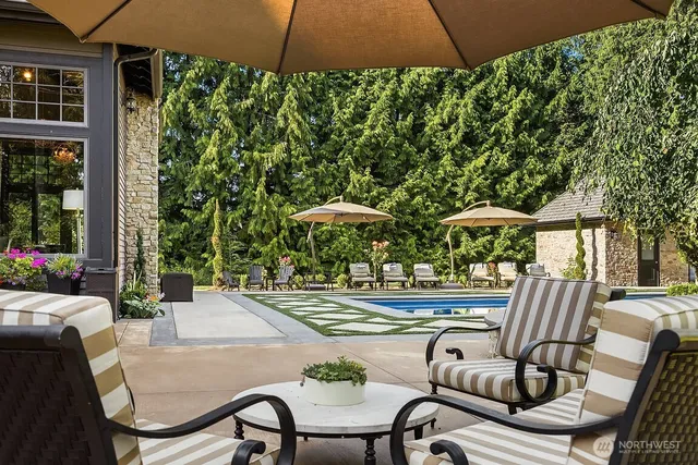 a view of a patio with table and chairs under an umbrella