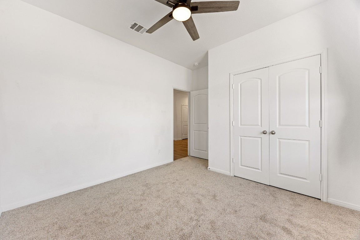 907 Youth Water Road Montgomery, TX 77316 - Photo 16 of 31 an empty room with a ceiling fan and window