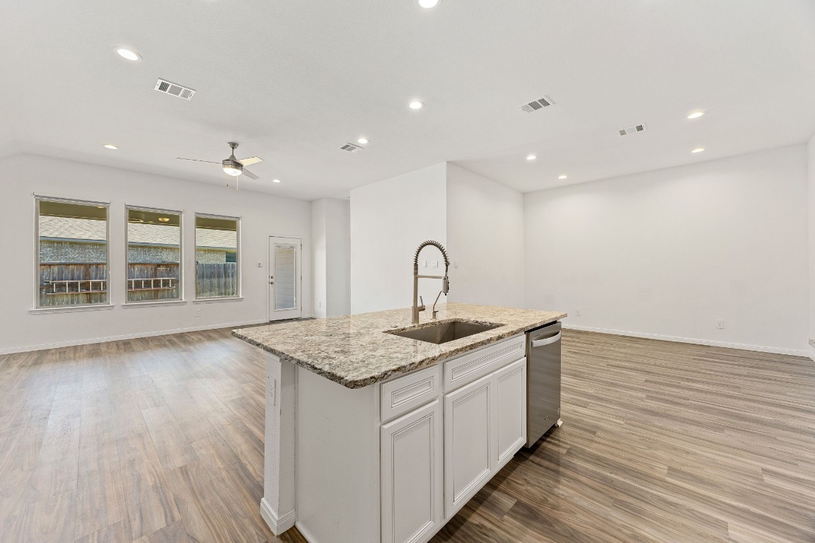 907 Youth Water Road Montgomery, TX 77316 - Photo 7 of 31 a kitchen with a sink and wooden floor