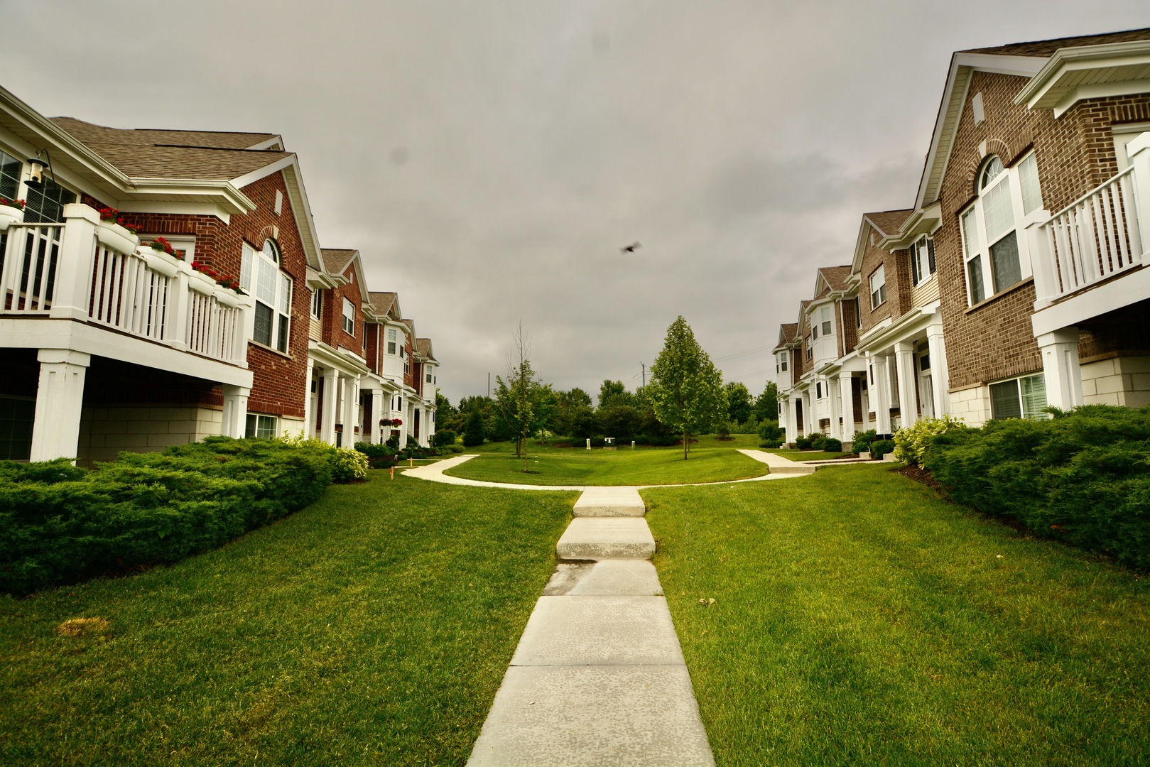 2953 Madison Drive, Unit 2953 Naperville, IL 60564 - Photo 17 of 18 a view of a big building with a big yard and potted plants