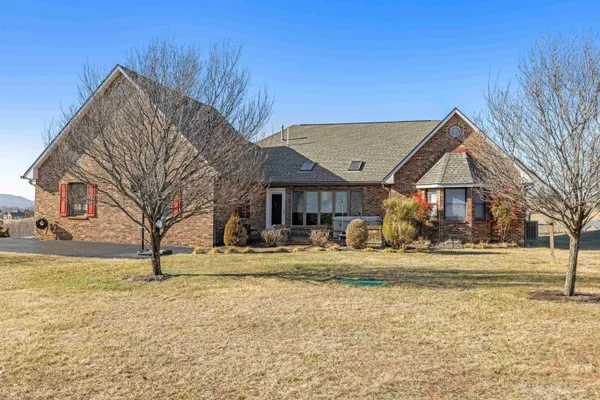 an aerial view of a house with a yard and mountain view