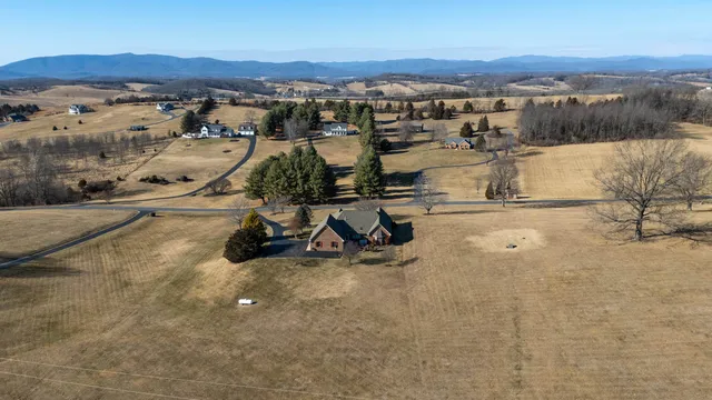 a bedroom with a white bed and a ceiling fan