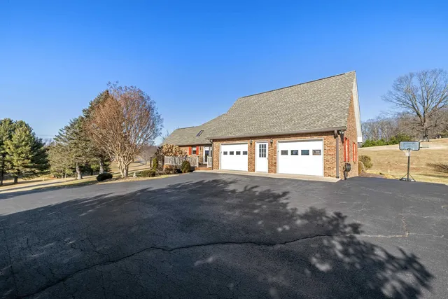 a view of an empty room with a fireplace and a window
