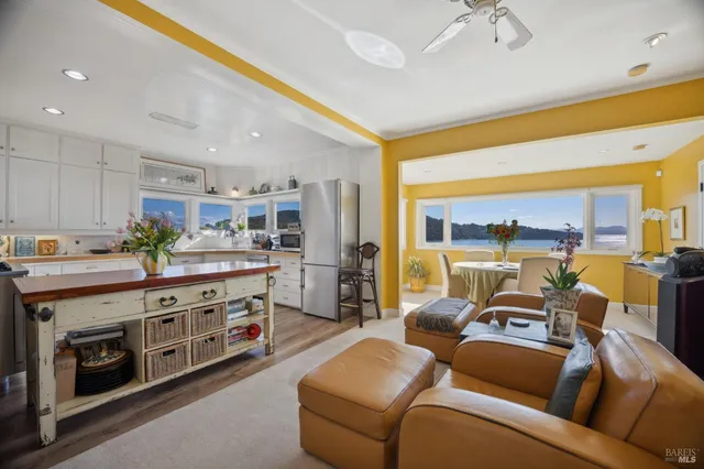 a view of living room with furniture and a kitchen view