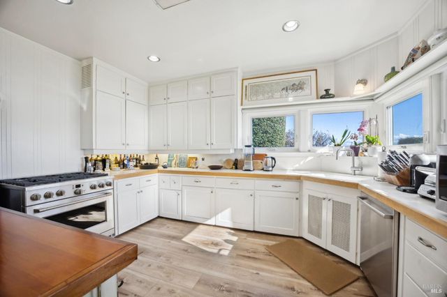 a kitchen with a sink stove and cabinets