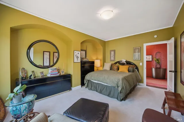 a spacious bedroom with two beds and a couch