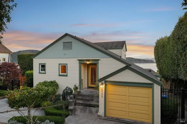 a front view of house along with trees