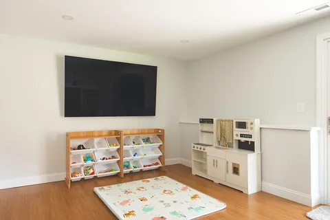 a living room with a flat screen tv and a couch