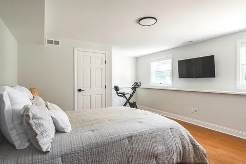 a bedroom with a bed and a flat screen tv