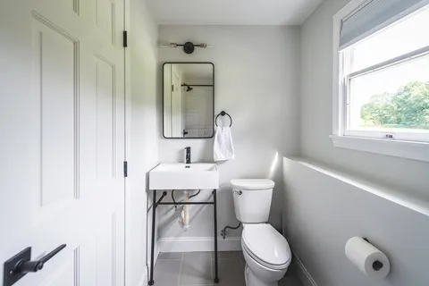 a white toilet sitting next to a bathroom sink