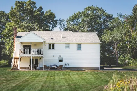 a aerial view of a house with a garden and swimming pool