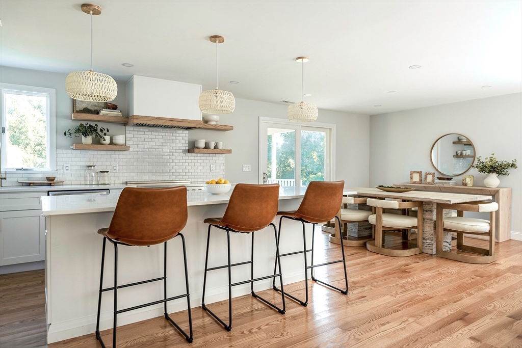 22 Sagamore Road Ipswich, MA 01938 - Photo 4 of 39 a kitchen with stainless steel appliances granite countertop a table chairs stove a sink dishwasher and cabinets with wooden floor