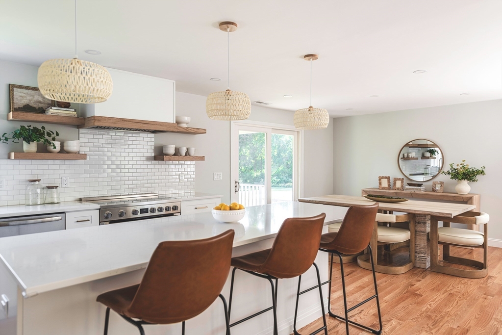 22 Sagamore Road Ipswich, MA 01938 - Photo 9 of 39 a kitchen with a dining table chairs and white cabinets