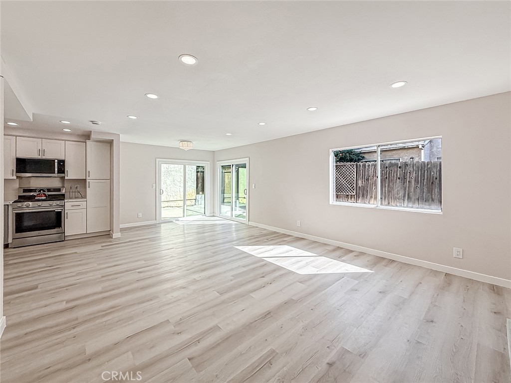 12392 Carl Street Pacoima, CA 91331 - Photo 13 of 55 a view of empty room with wooden floor and windows