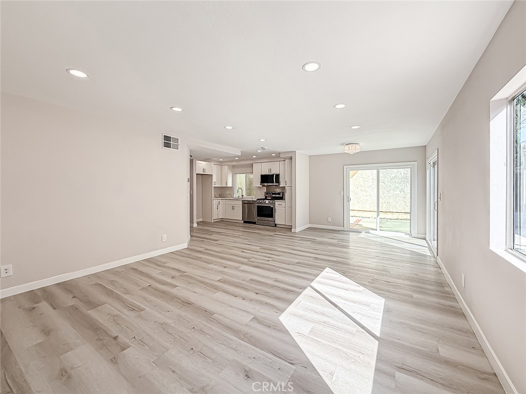 12392 Carl Street Pacoima, CA 91331 - Photo 14 of 55 a view of empty room with wooden floor