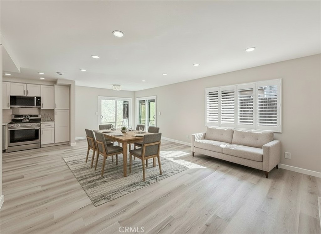12392 Carl Street Pacoima, CA 91331 - Photo 15 of 55 a view of a dining room with furniture and wooden floor