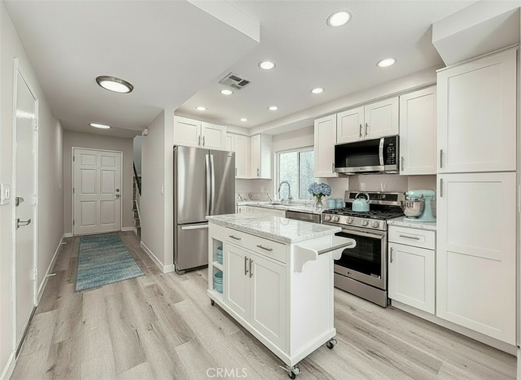 12392 Carl Street Pacoima, CA 91331 - Photo 17 of 55 a kitchen with stainless steel appliances a stove a sink a refrigerator and a microwave