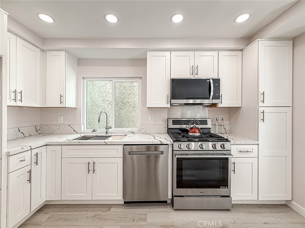12392 Carl Street Pacoima, CA 91331 - Photo 19 of 55 a kitchen with a stove and a sink