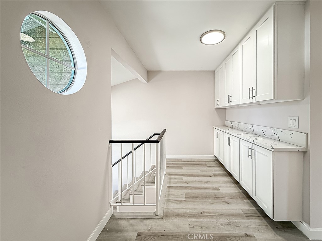 12392 Carl Street Pacoima, CA 91331 - Photo 26 of 55 a view of a hallway with wooden floor and entryway