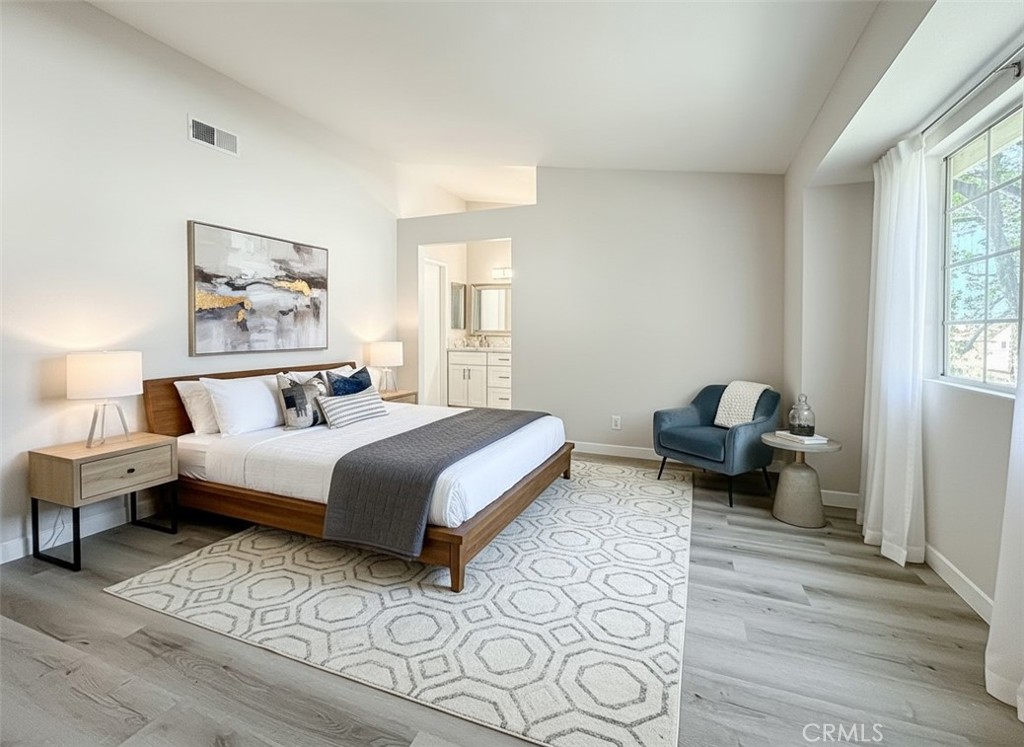 12392 Carl Street Pacoima, CA 91331 - Photo 27 of 55 a spacious bedroom with a bed and wooden floor