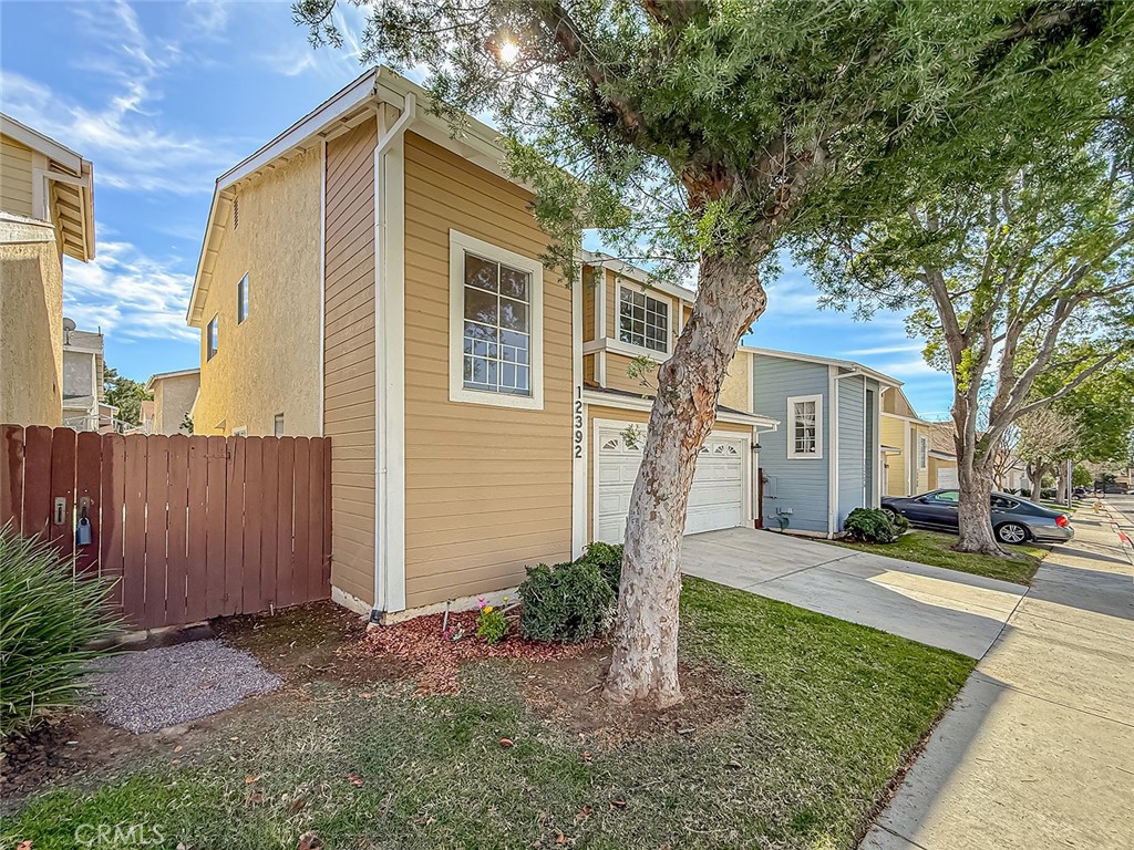 12392 Carl Street Pacoima, CA 91331 - Photo 3 of 55 a front view of a house with a yard