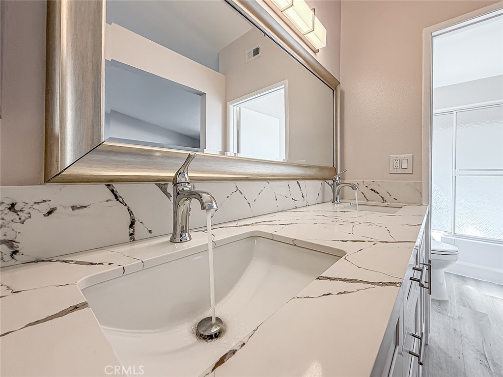 12392 Carl Street Pacoima, CA 91331 - Photo 33 of 55 a bathroom with a sink and a mirror