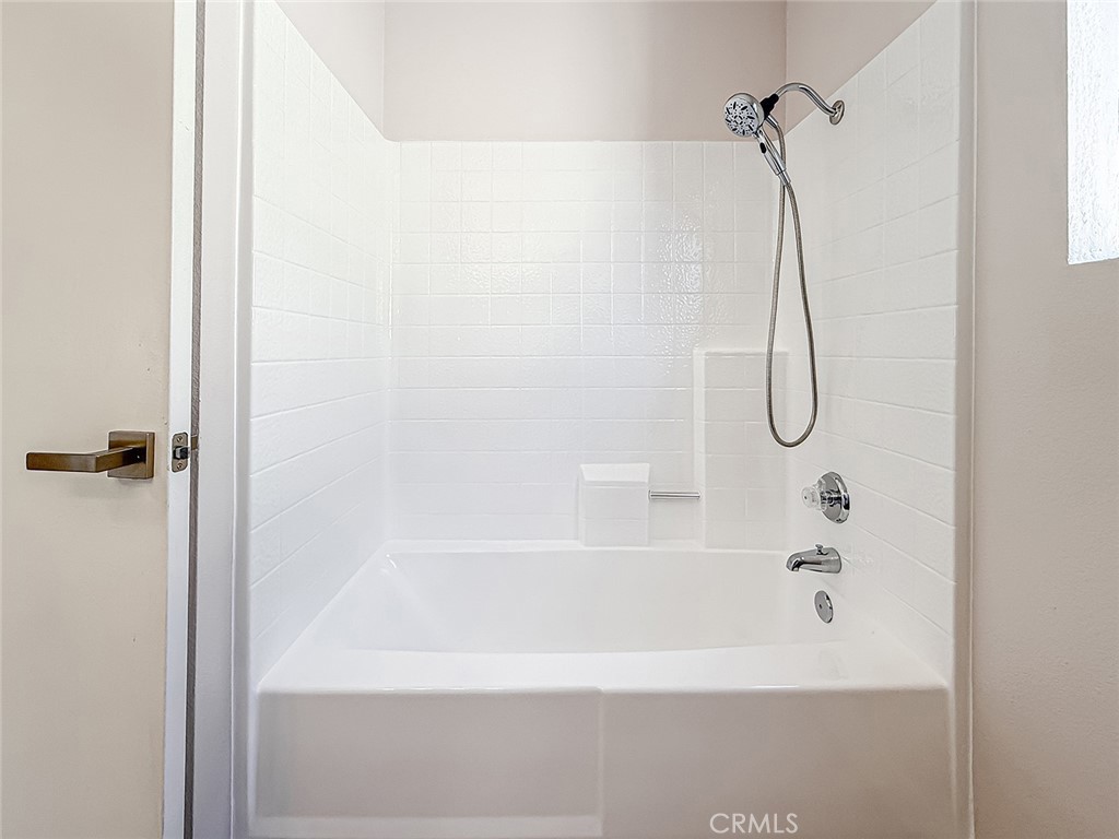 12392 Carl Street Pacoima, CA 91331 - Photo 45 of 55 a bathroom with a bath tub with a shower