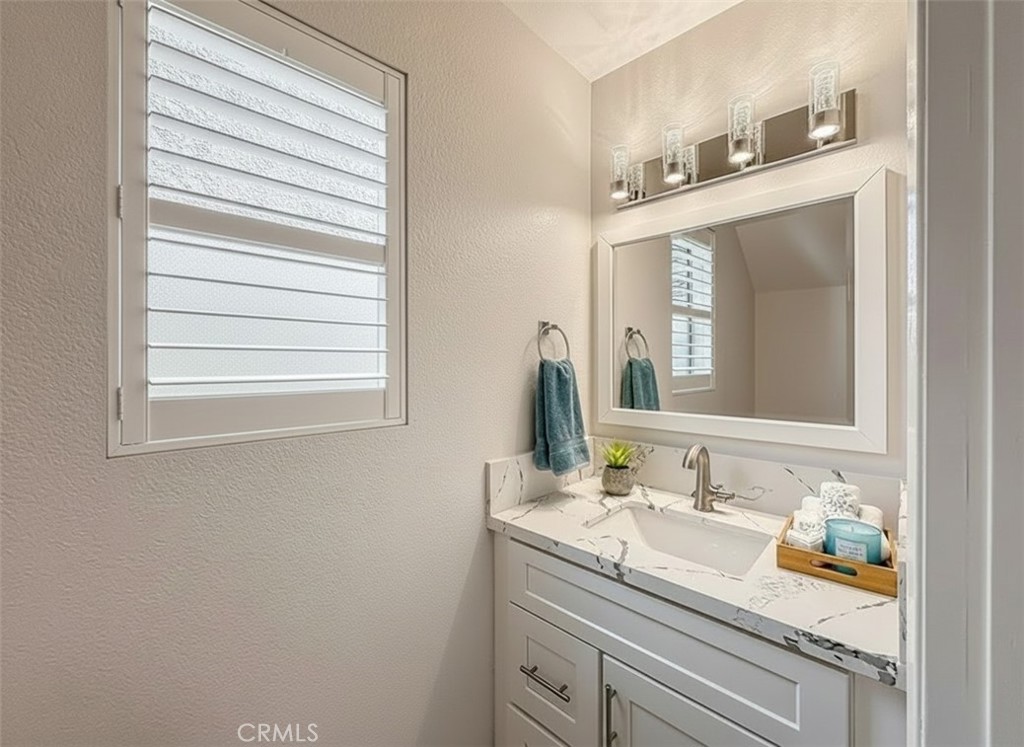12392 Carl Street Pacoima, CA 91331 - Photo 7 of 55 a bathroom with a granite countertop sink and a mirror