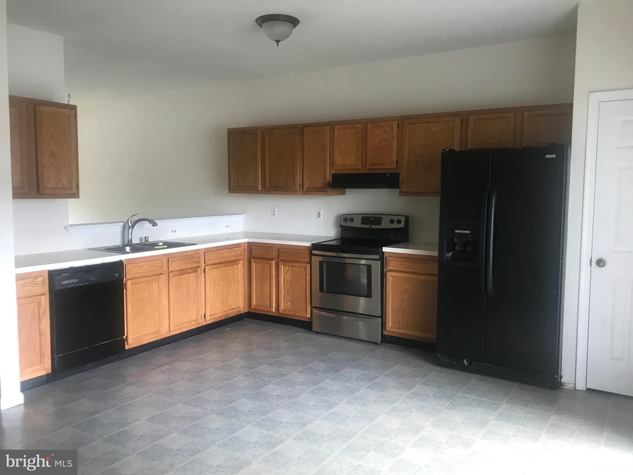 122 Cherry Tree Lane Elkton, MD 21921 - Photo 3 of 7 a kitchen with a sink a stove and refrigerator