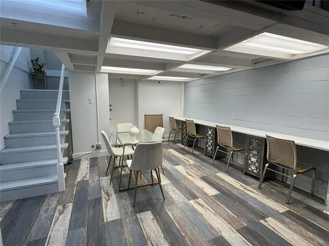 a dining room with furniture and wooden floor