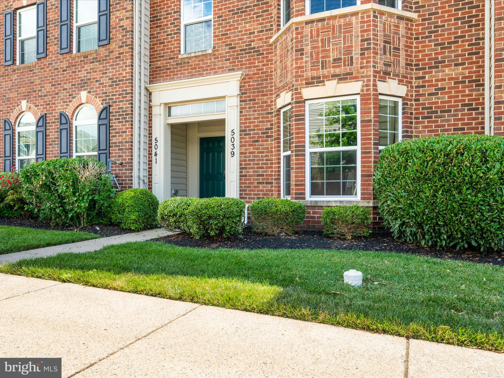 5039 Small Gains Way Frederick, MD 21703 - Photo 1 of 34 a front view of a brick house with a yard