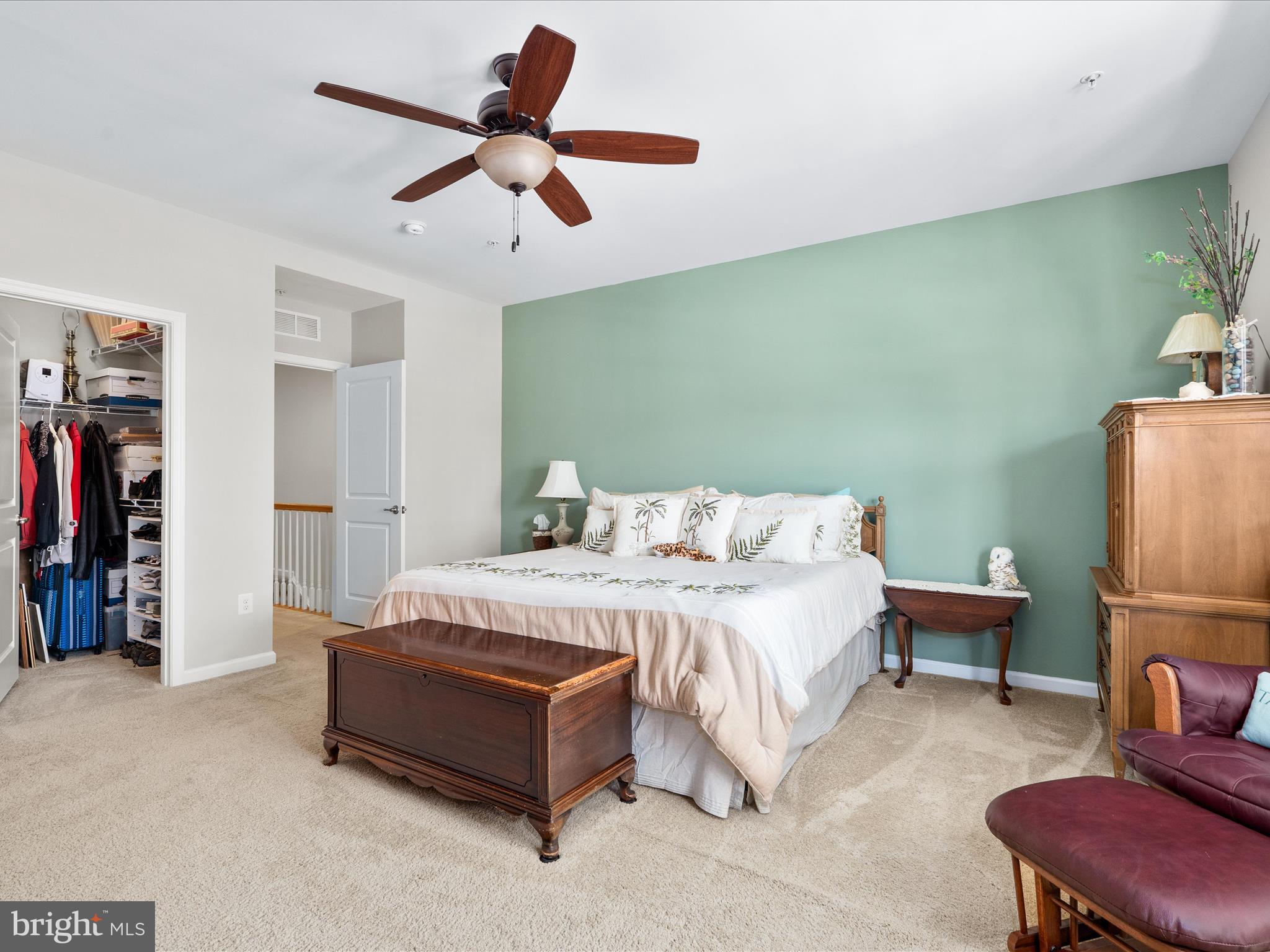 5039 Small Gains Way Frederick, MD 21703 - Photo 19 of 34 a spacious bedroom with a bed a couch and a chandelier