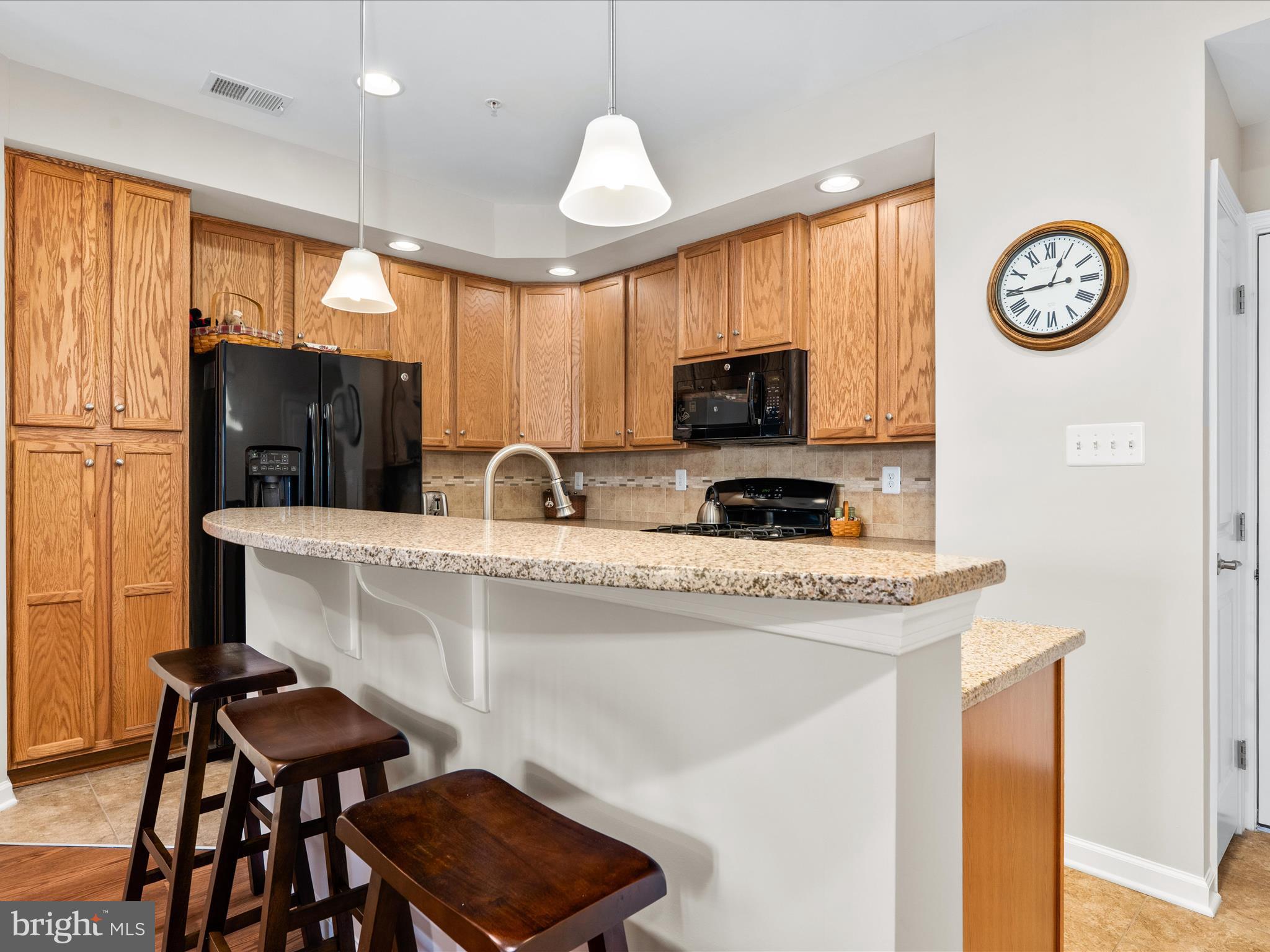 5039 Small Gains Way Frederick, MD 21703 - Photo 3 of 34 a kitchen with stainless steel appliances a stove a sink a microwave a refrigerator and cabinets